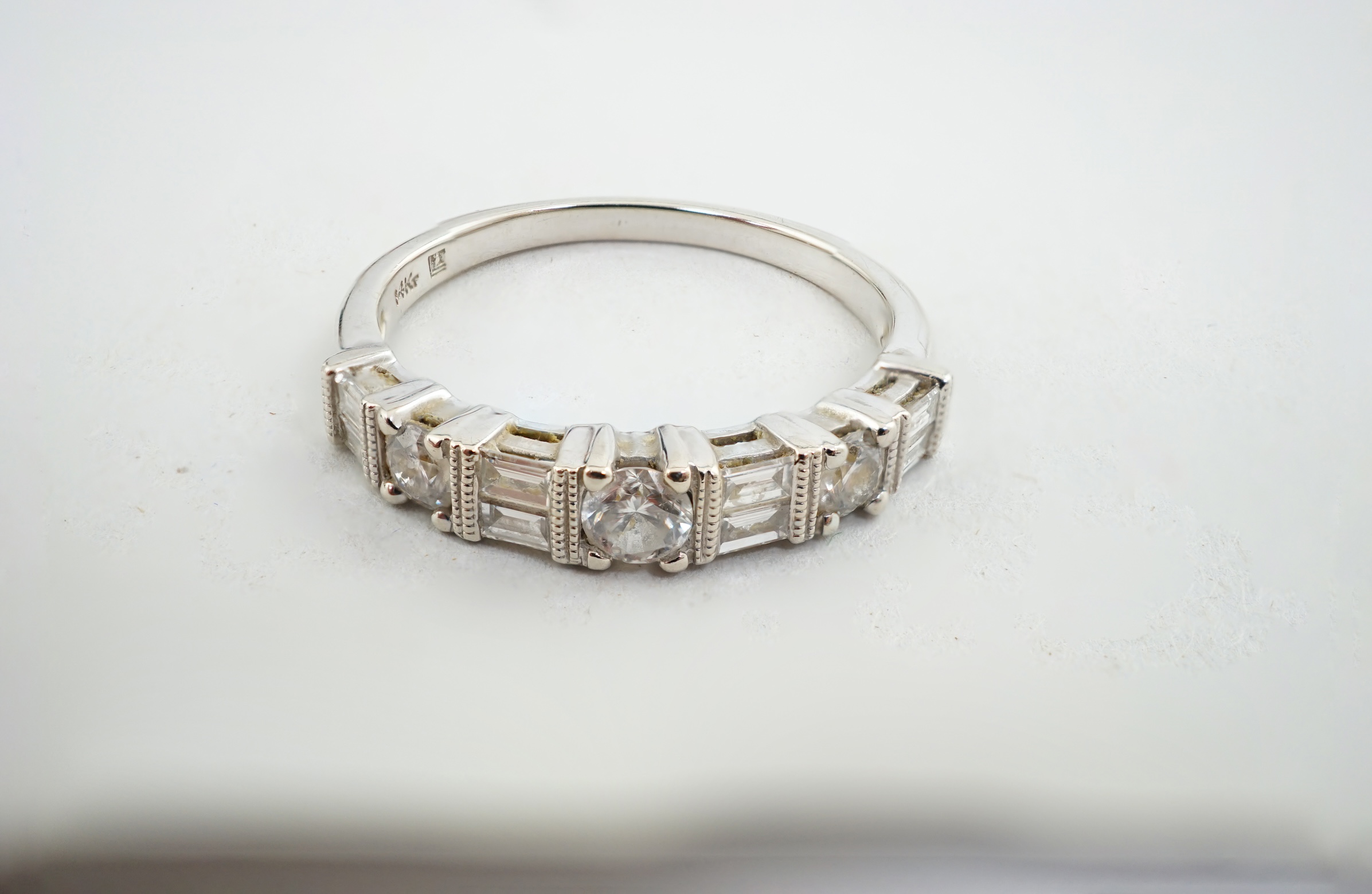 A modern 14k white gold, baguette and round cut diamond set half eternity ring